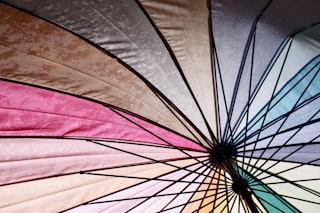 a close up of a colorful umbrella that is open