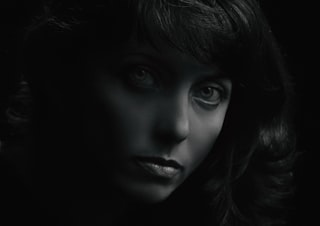 grayscale photo of womans face