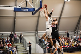 man holding ball dunk in ring