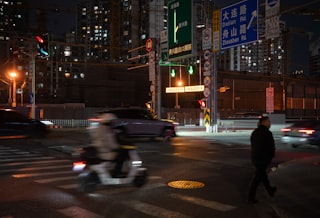 City street at night with traffic and illuminated buildings